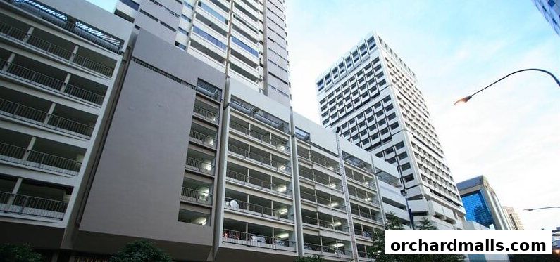 Modern multi-story building with a parking garage and office spaces.