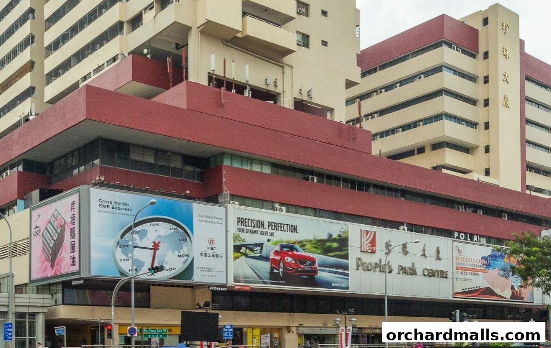 Exterior view of People's Park Centre with various advertisements on its facade.