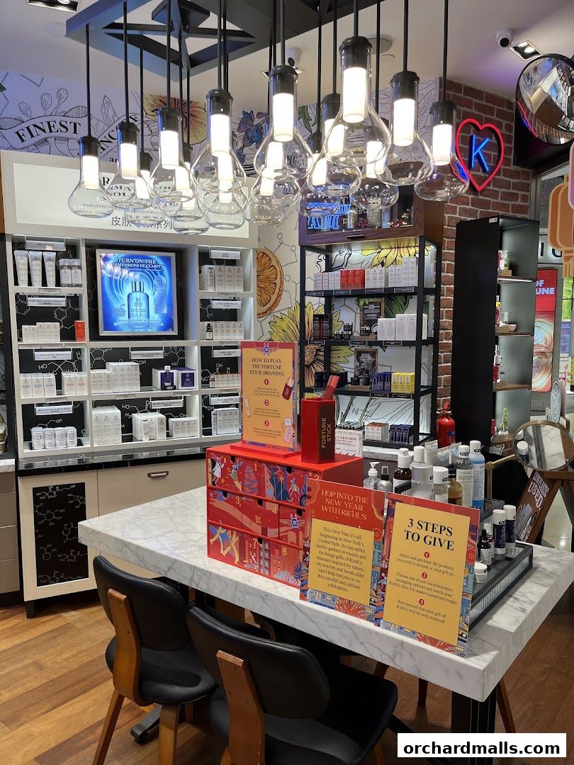 Interior view of a Kiehl's store with skincare products displayed and promotional signage.