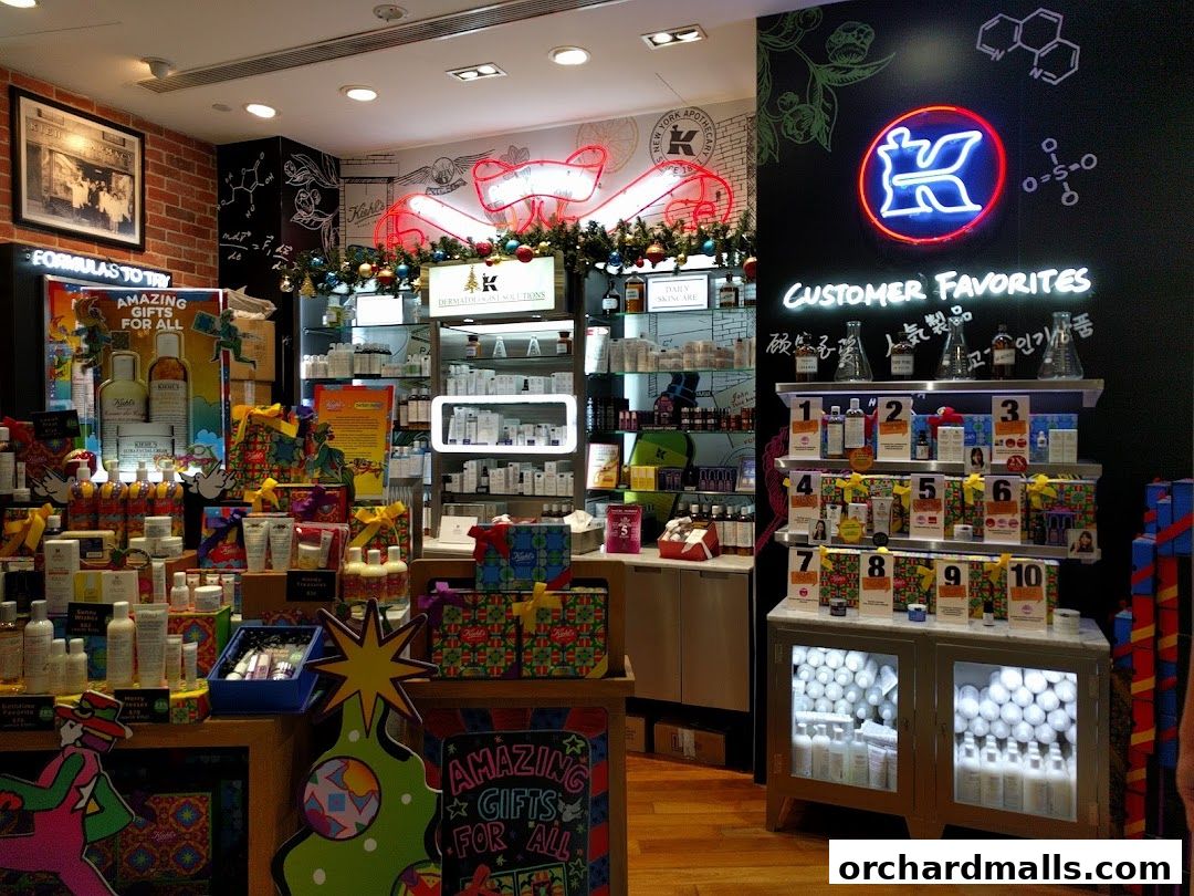 Kiehl's store interior showcasing skincare products, gift sets, and holiday decorations.
