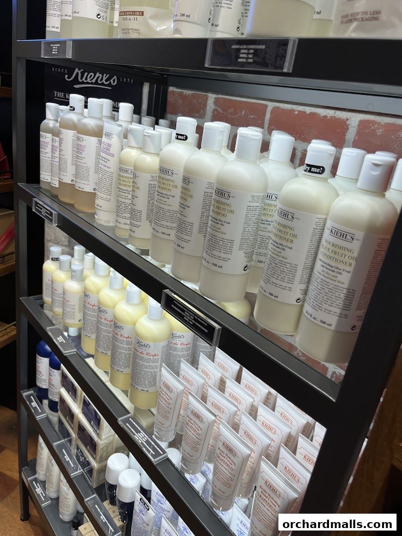 Shelves stocked with Kiehl's skincare products, including large bottles and smaller tubes.