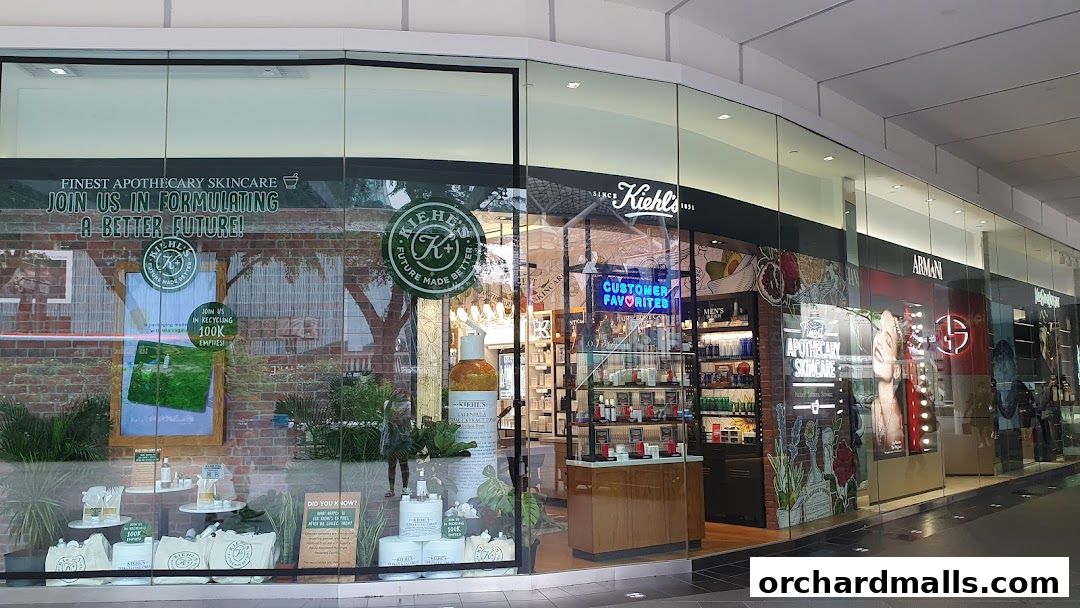 The storefront of Kiehl's, featuring skincare products and a 'Customer Favorites' neon sign.