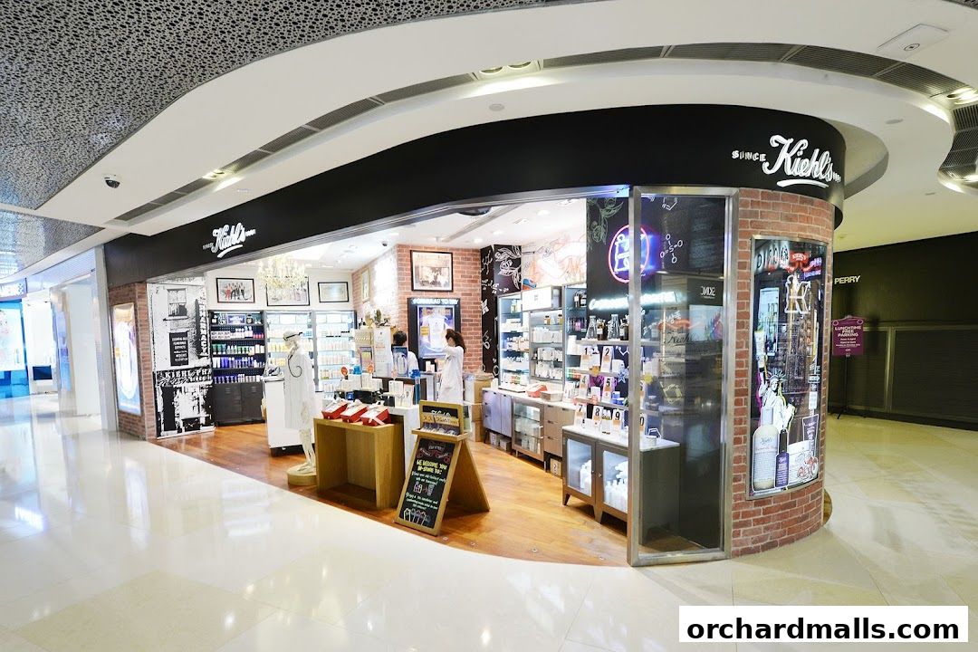 Kiehl's store interior with skincare products and staff assisting customers.