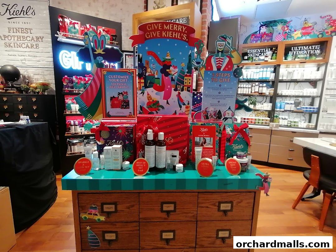 A display of Kiehl's skincare products and gift sets, decorated for the holidays.