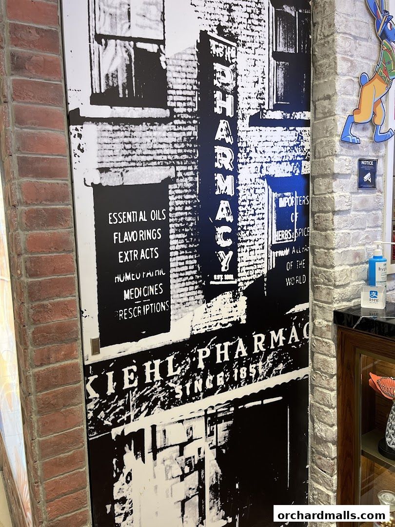 Kiehl's Pharmacy vintage-style mural with product categories listed.