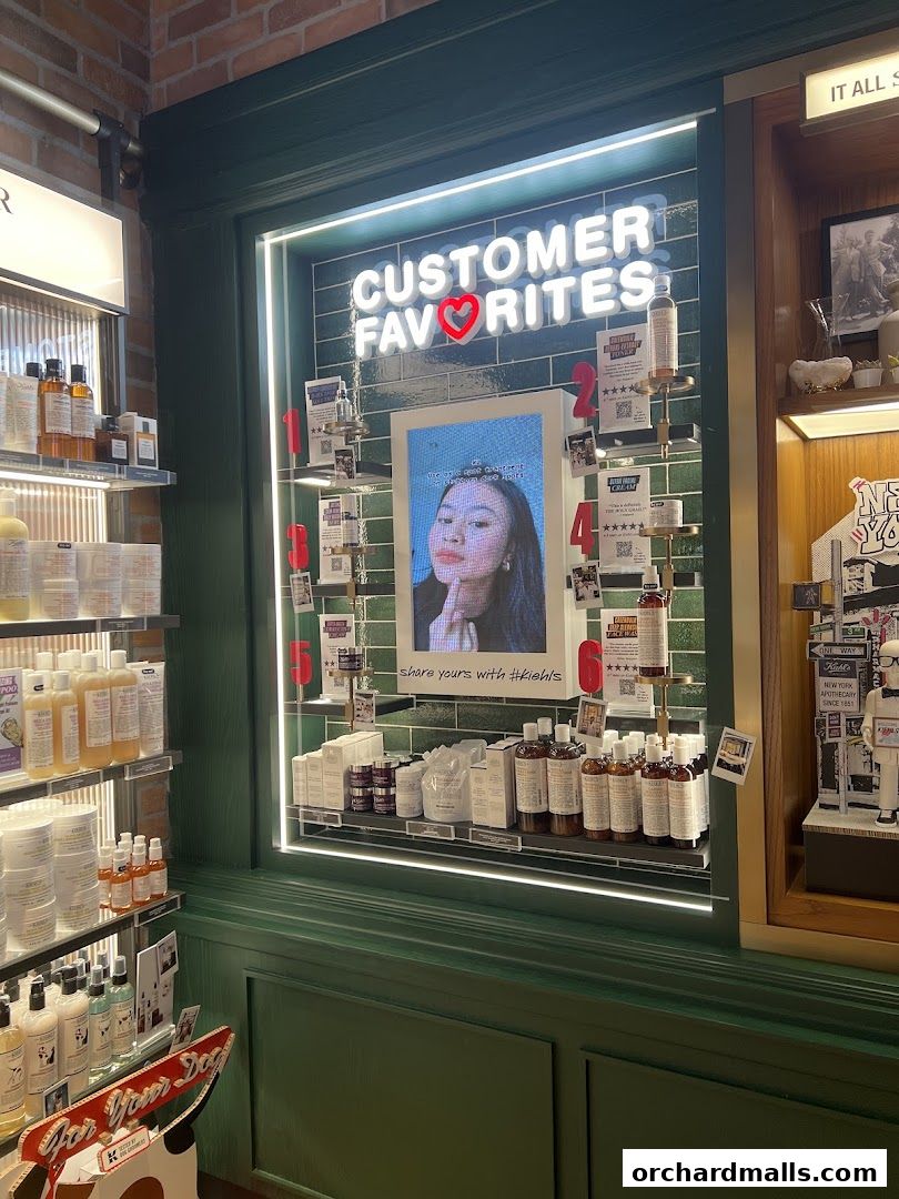 Kiehl's store display featuring customer favorite products and a promotional video.