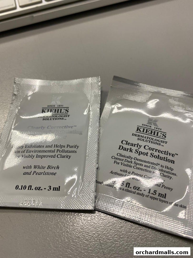 Two Kiehl's sample packets for Clearly Corrective Dark Spot Solution and Brightening Exfoliating Cleanser.