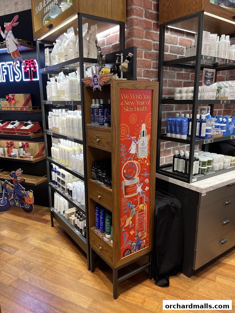 Interior shot of a Kiehl's store showcasing skincare products and a New Year's promotion.
