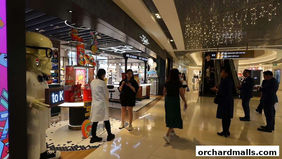 Kiehl's store interior with staff and customers, featuring a large skeleton mascot.