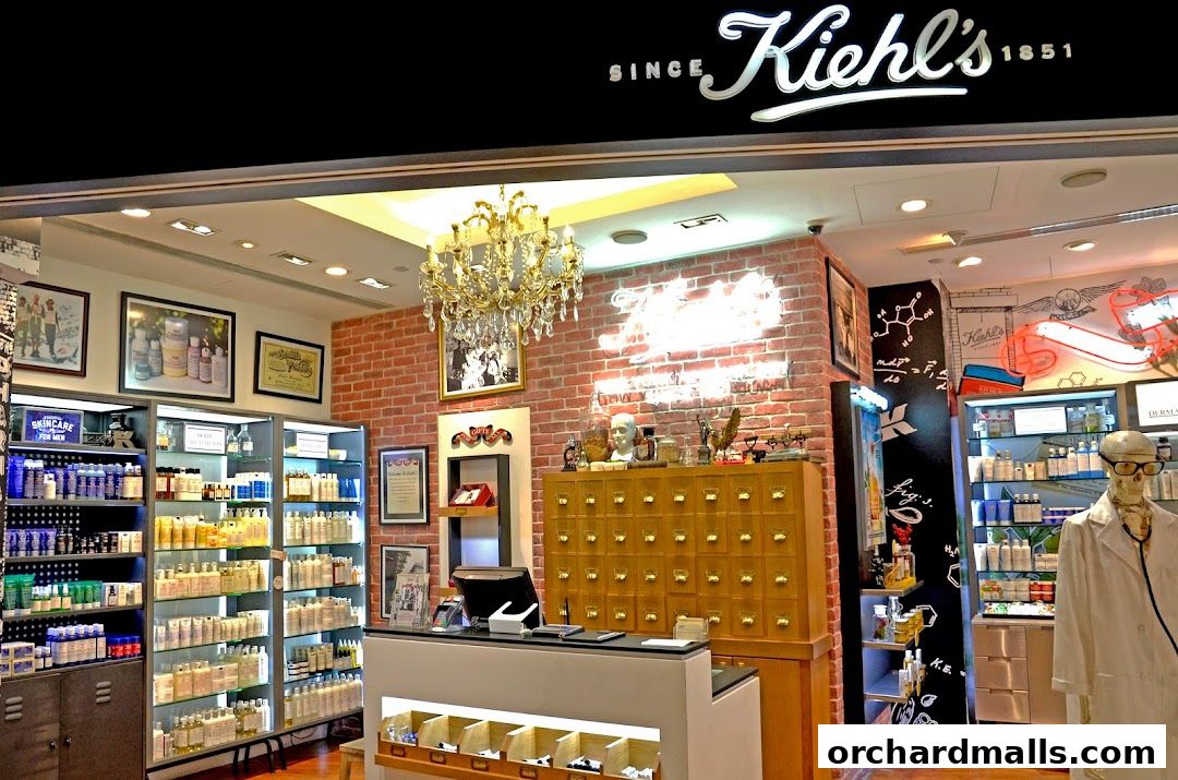 Interior of Kiehl's Ion Orchard store with products displayed on shelves and a skeleton mannequin.