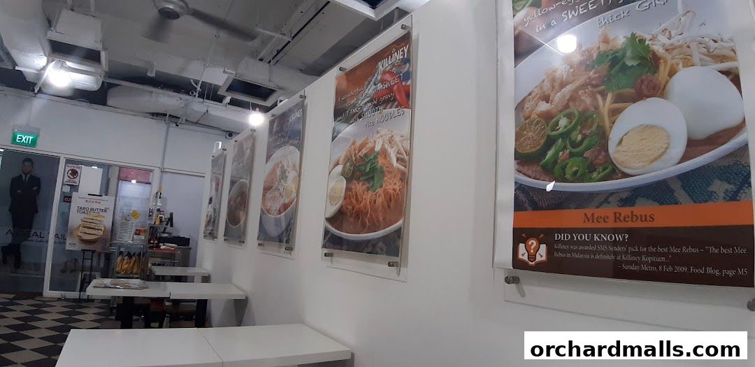 Interior view of Killiney Kopitiam with food posters and seating.