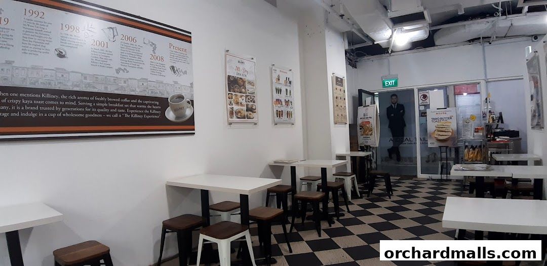 Interior of Killiney Kopitiam with tables, chairs, and historical timeline on the wall.