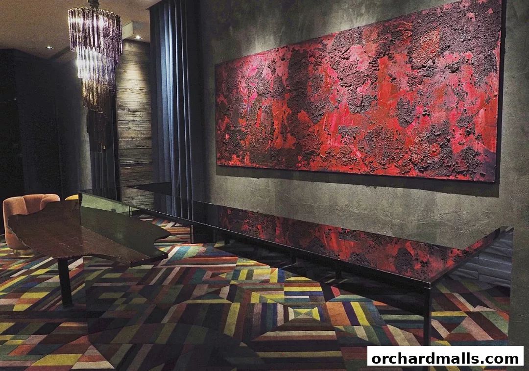 Interior of a stylish room with abstract art, a chandelier, and a colorful geometric carpet.