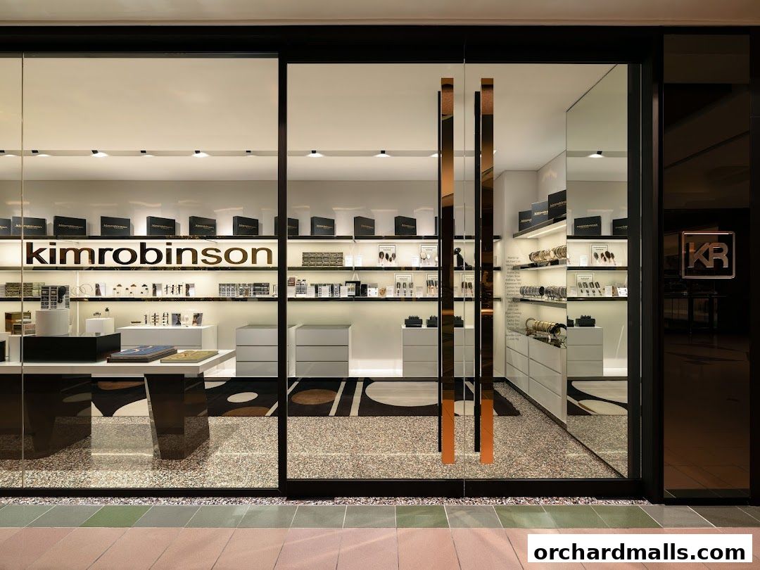 The modern storefront of kimrobinson, showcasing luxury watches and accessories on illuminated shelves.