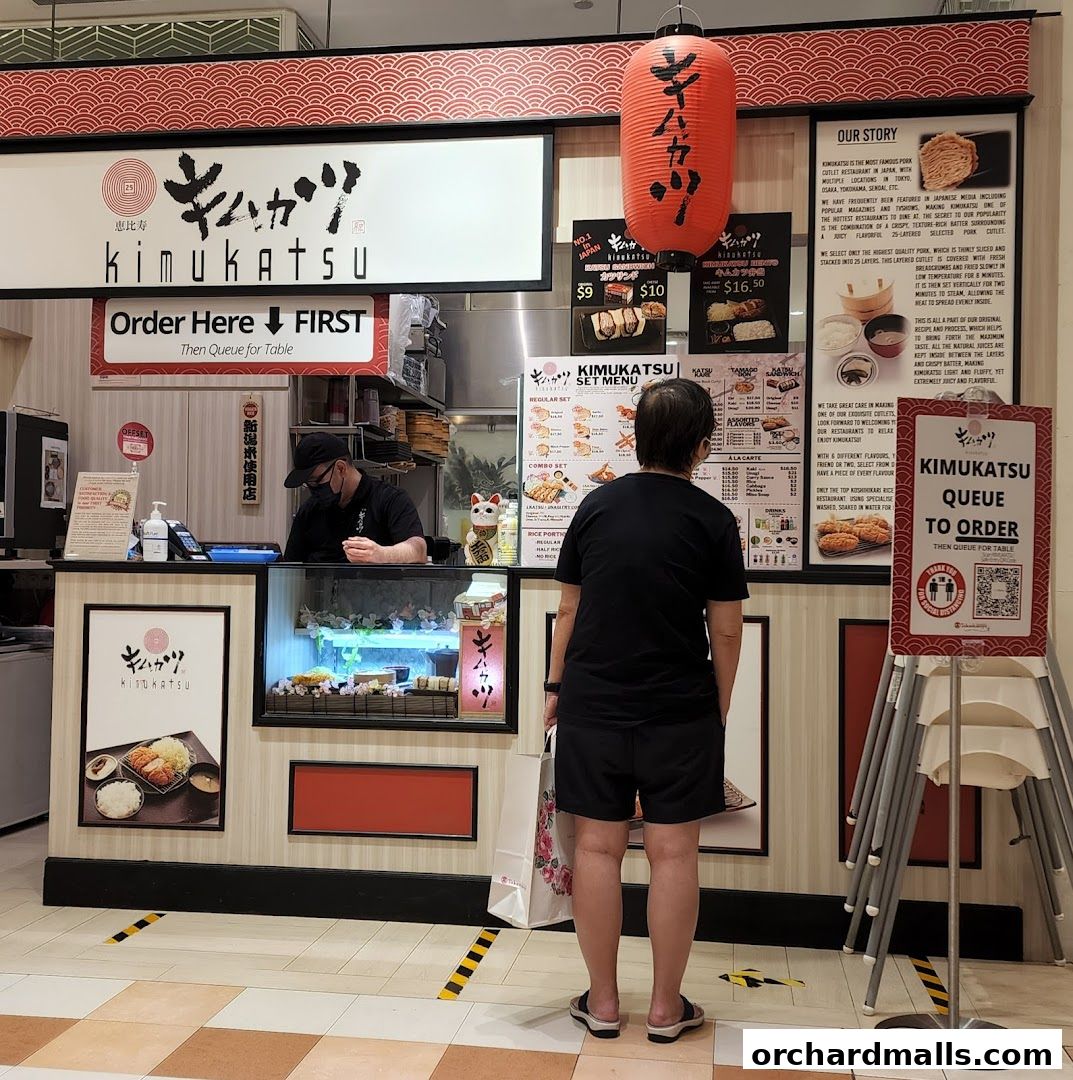 A customer orders at the counter of Kimukatsu, a Japanese pork cutlet restaurant.