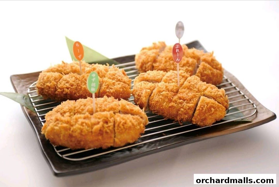 A plate of delicious, golden-brown katsu cutlets served on a wire rack.