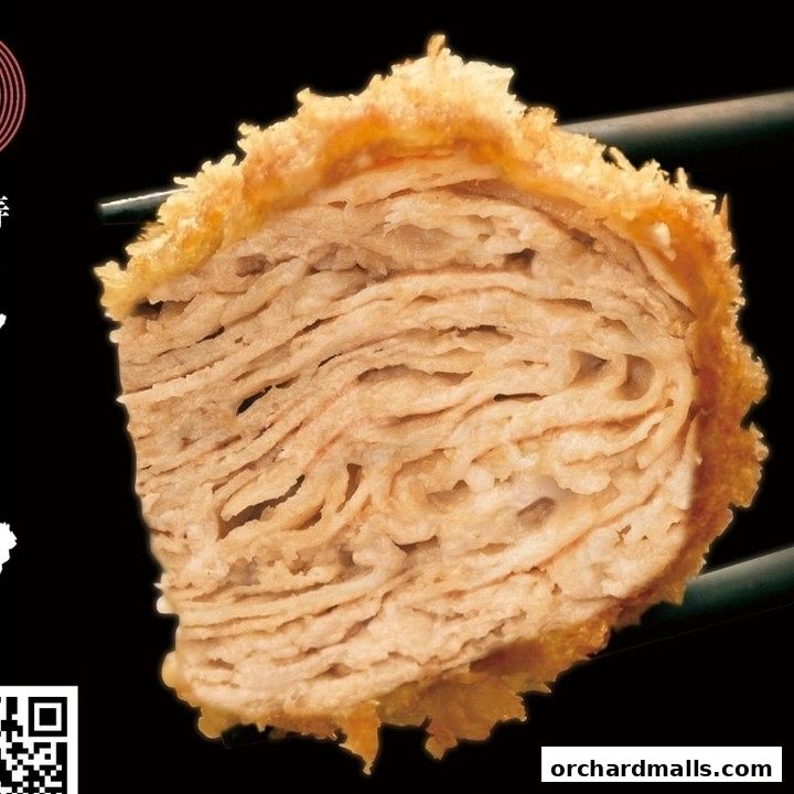 A close-up of a layered, breaded and fried pork cutlet, held by chopsticks.