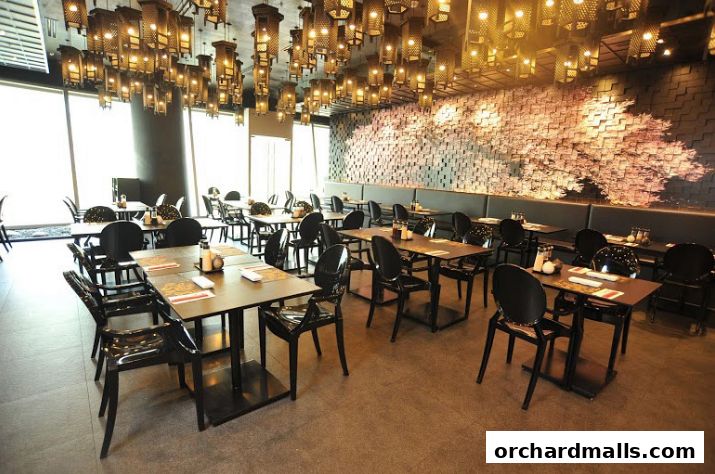 Interior of a restaurant with tables, chairs, and decorative lighting.