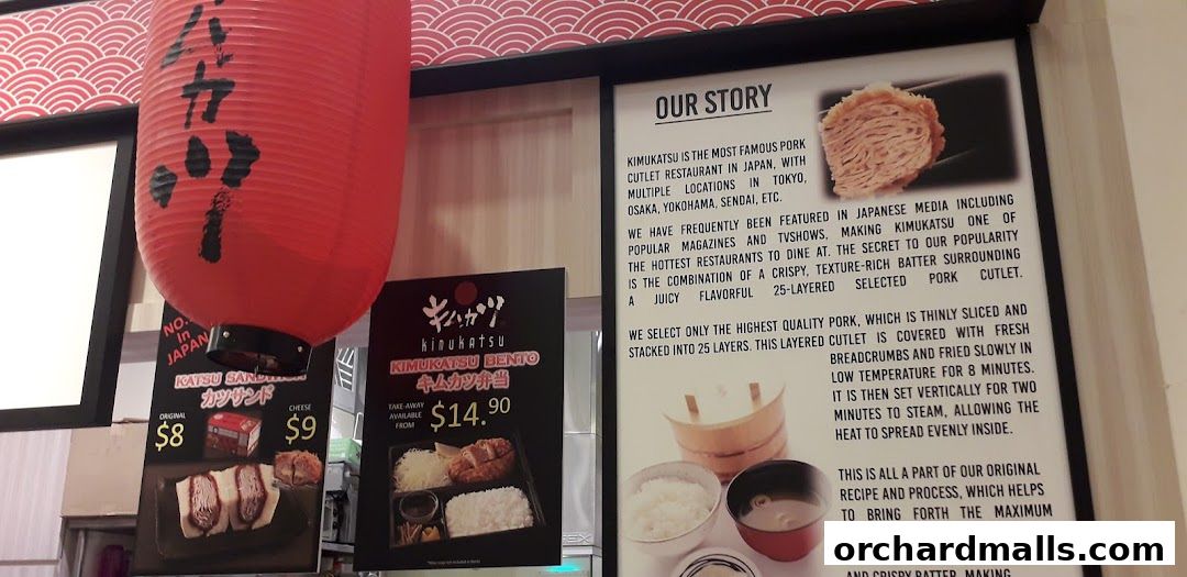 A sign for Kimukatsu restaurant showcasing their famous pork cutlet bento and katsu sandwiches.