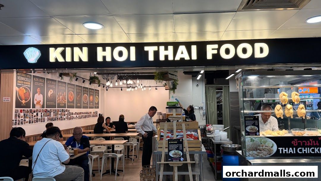 Kin Hoi Thai Food restaurant interior with customers and a display of roasted chickens.