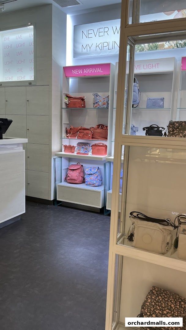 Interior view of a Kipling store showcasing various bags and accessories on display shelves.