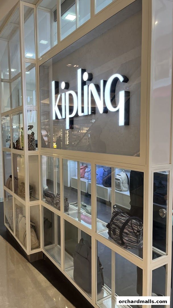 The exterior of a Kipling store showcasing various bags in display shelves.