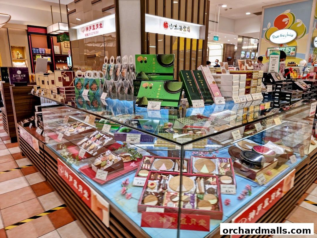 A display of beautifully packaged Japanese sweets and cookies in a retail store.
