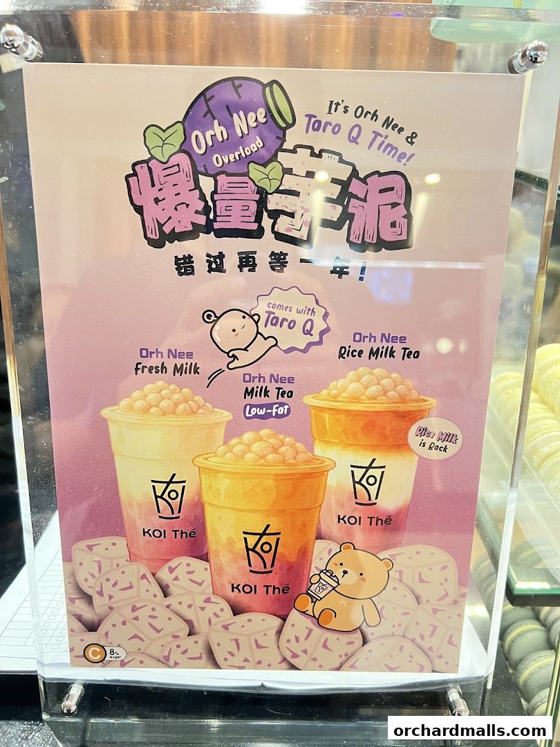 A menu board for KOI Thé featuring Orh Nee and Taro Q drinks with illustrations.