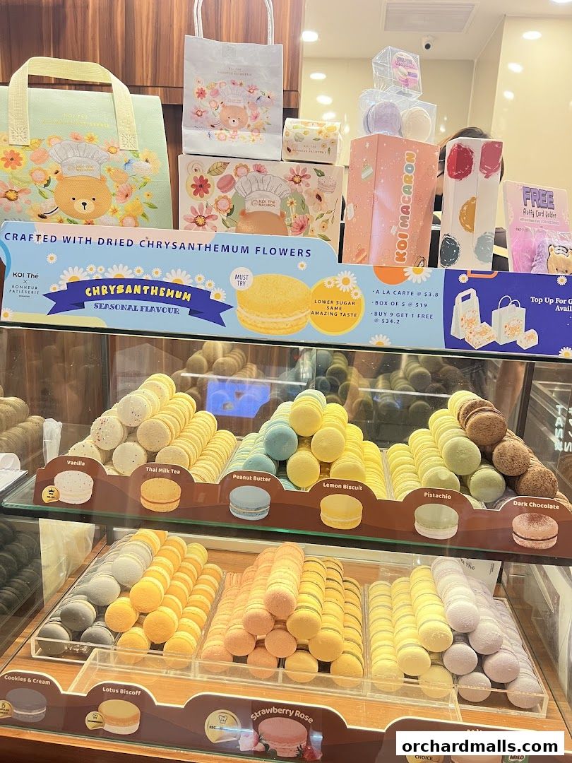 A display of colorful macarons and pastries from KOI Thé Express.
