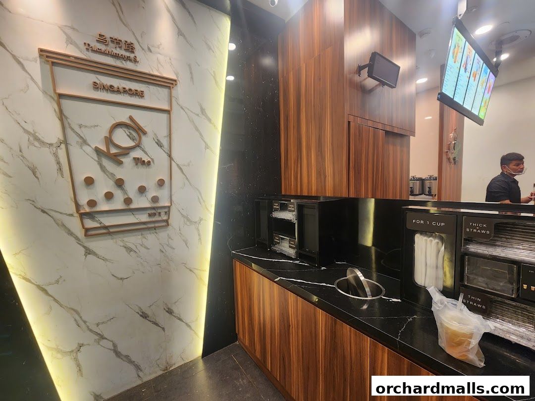 The interior of KOI Thé Express Takashimaya with a prominent logo and counter.