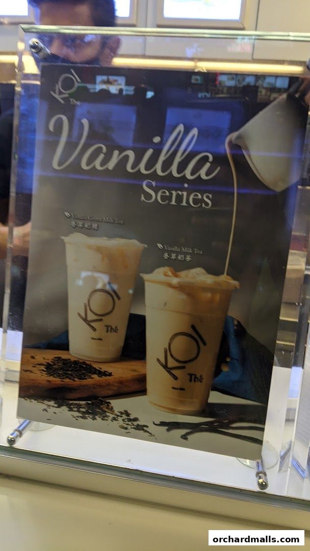 A sign advertising KOI Thé's Vanilla Series milk teas.