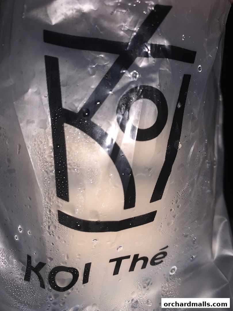 A close-up of a plastic bag with the KOI Thé logo and condensation.