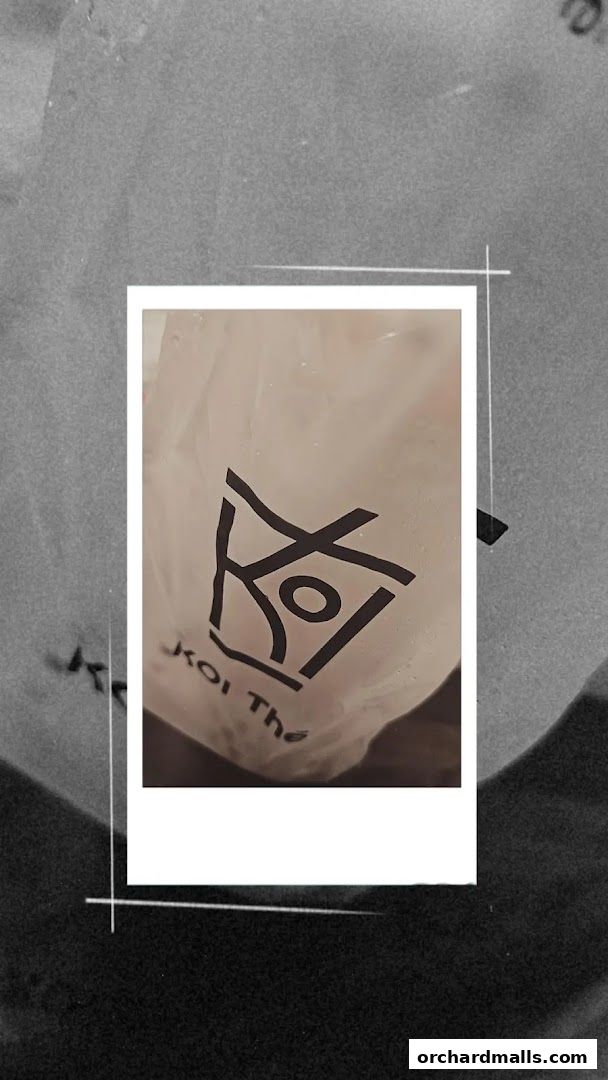 A close-up of a white plastic bag with the KOI Thé logo and text.