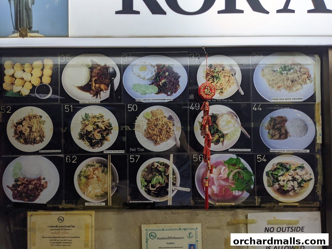 A display of various Thai food dishes with their names and numbers.