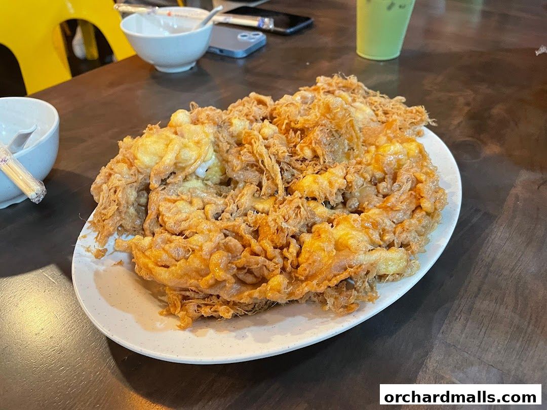 A plate of crispy fried omelet served on a table at Korat Thai Cafe.