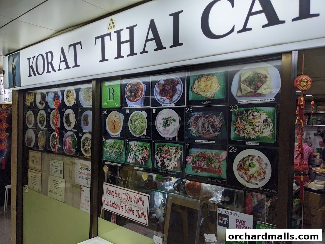 Exterior view of Korat Thai Cafe with a display of food images and menu items.