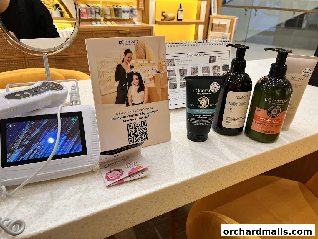 L'Occitane products and hair diagnostic equipment displayed on a counter.