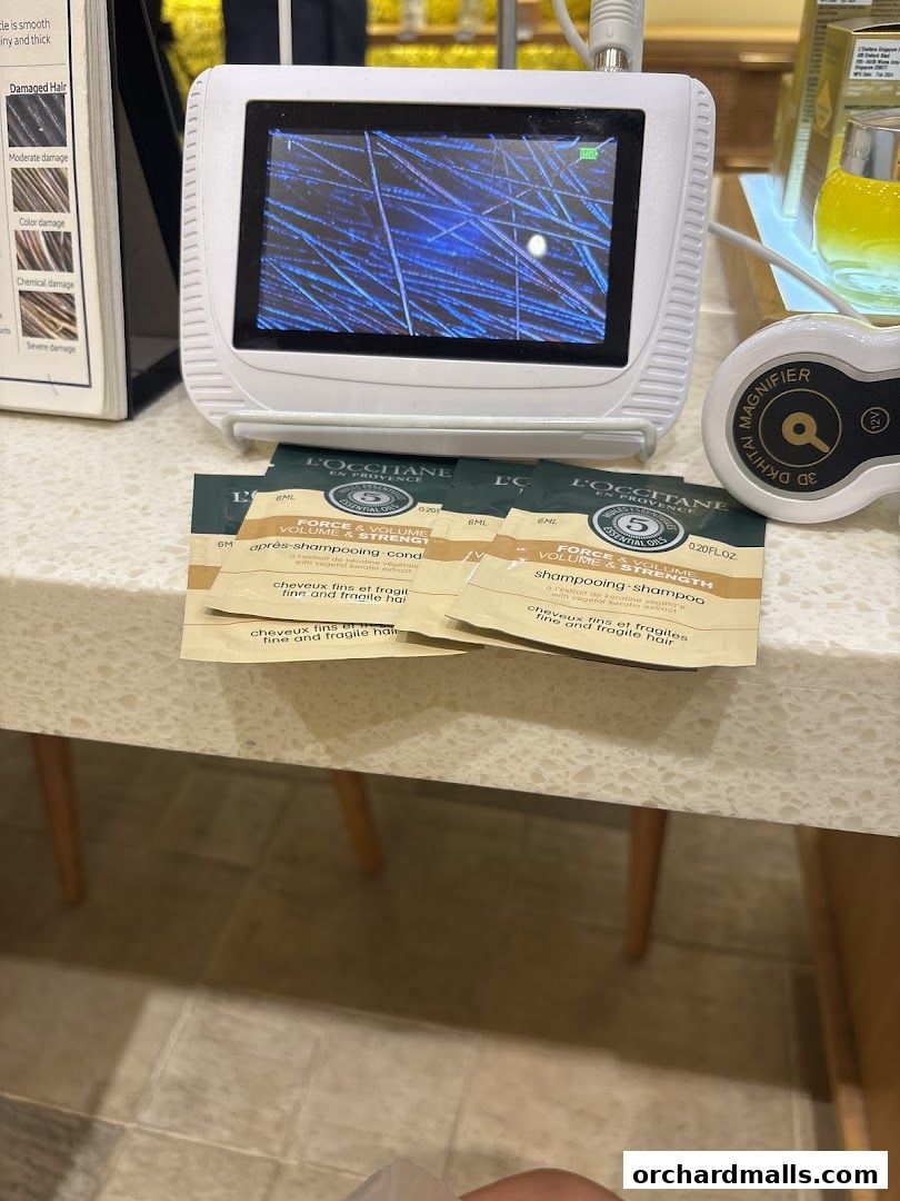 L'Occitane shop display featuring a hair analysis device and sample sachets.
