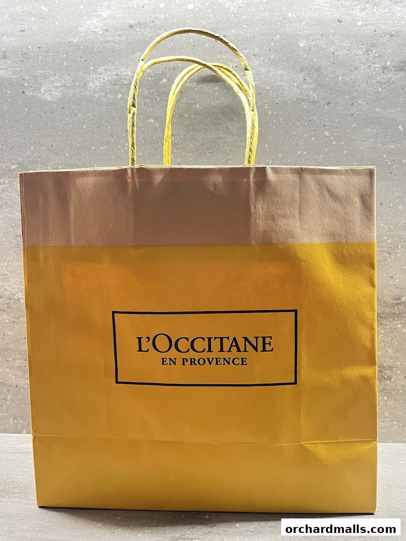 A yellow shopping bag with the L'OCCITANE en Provence logo.