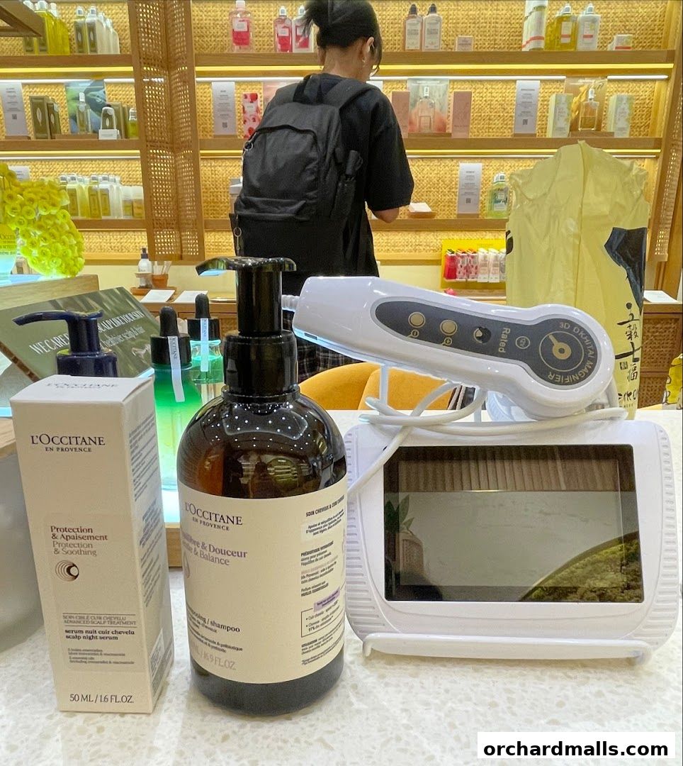L'Occitane products displayed with a customer browsing in the background.