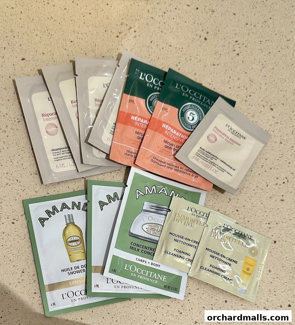 A collection of L'Occitane product samples including shampoo, serum, and cleansing cream.