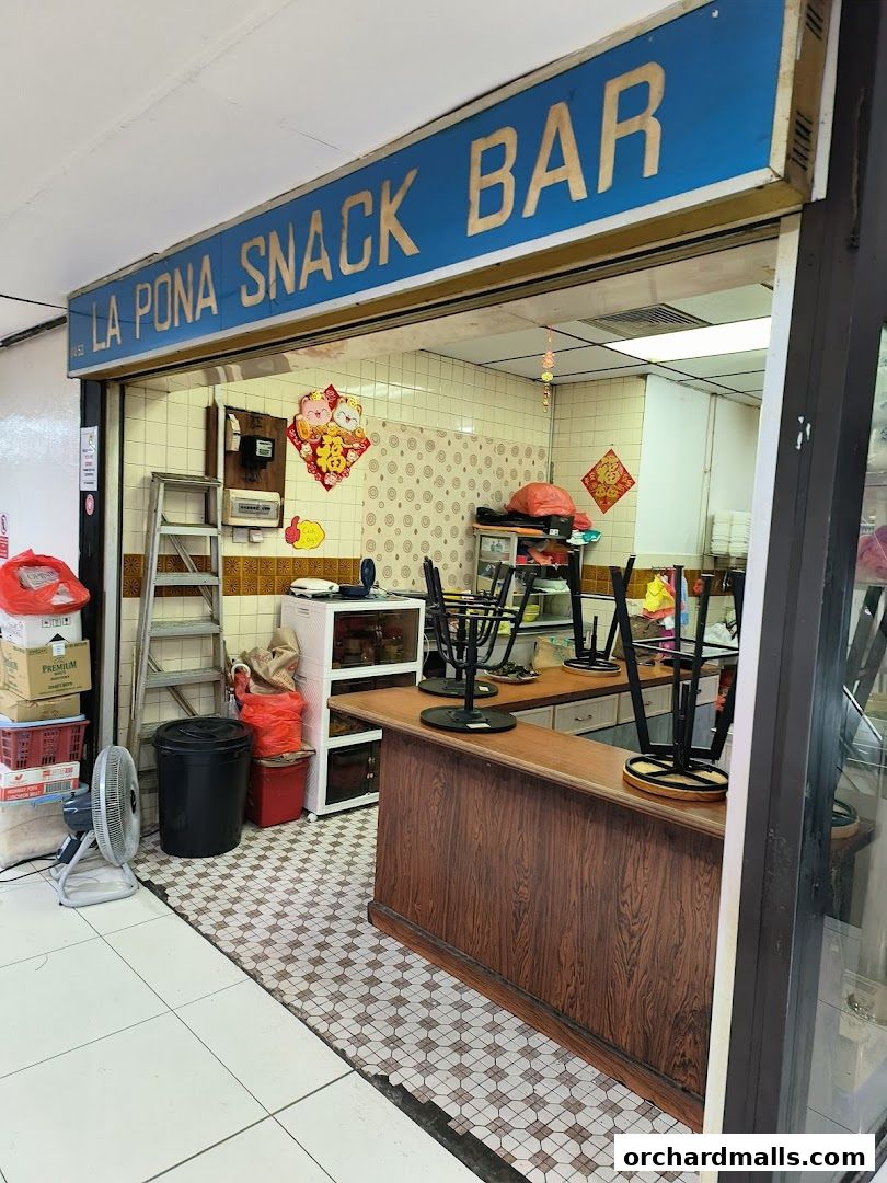 Exterior view of La Pona Snack Bar Nasi Lemak with its signage and counter.