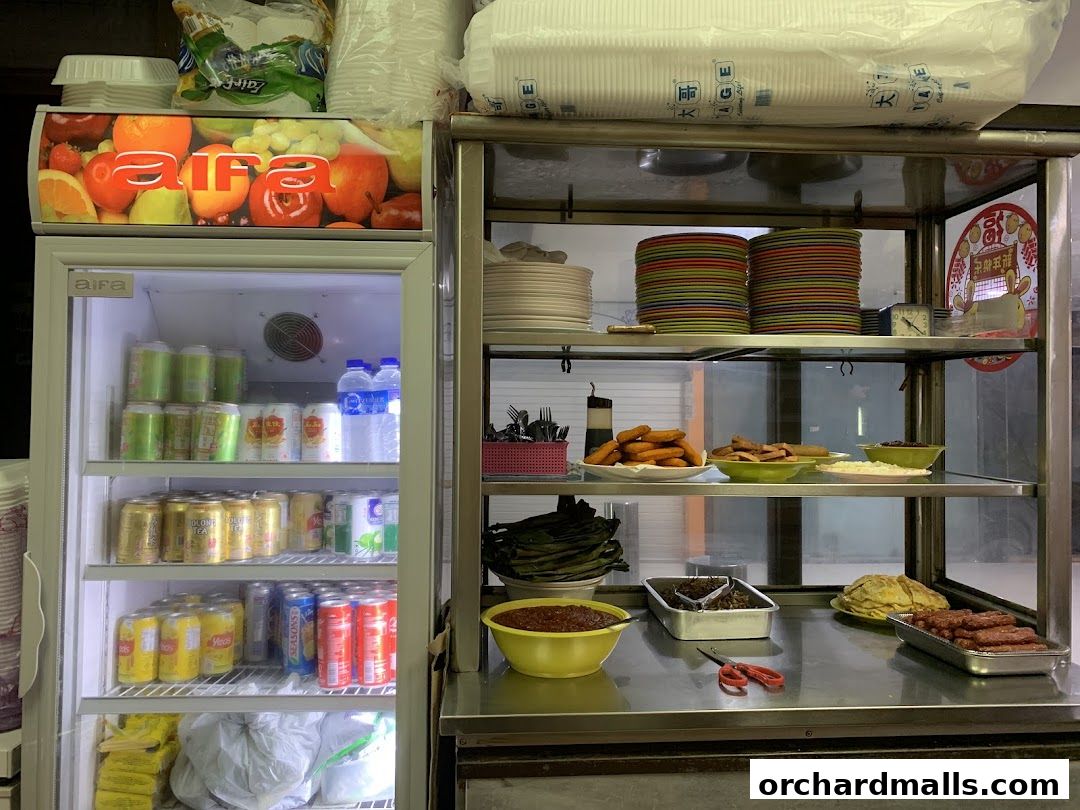 A display of drinks in a refrigerator and prepared food items on shelves.