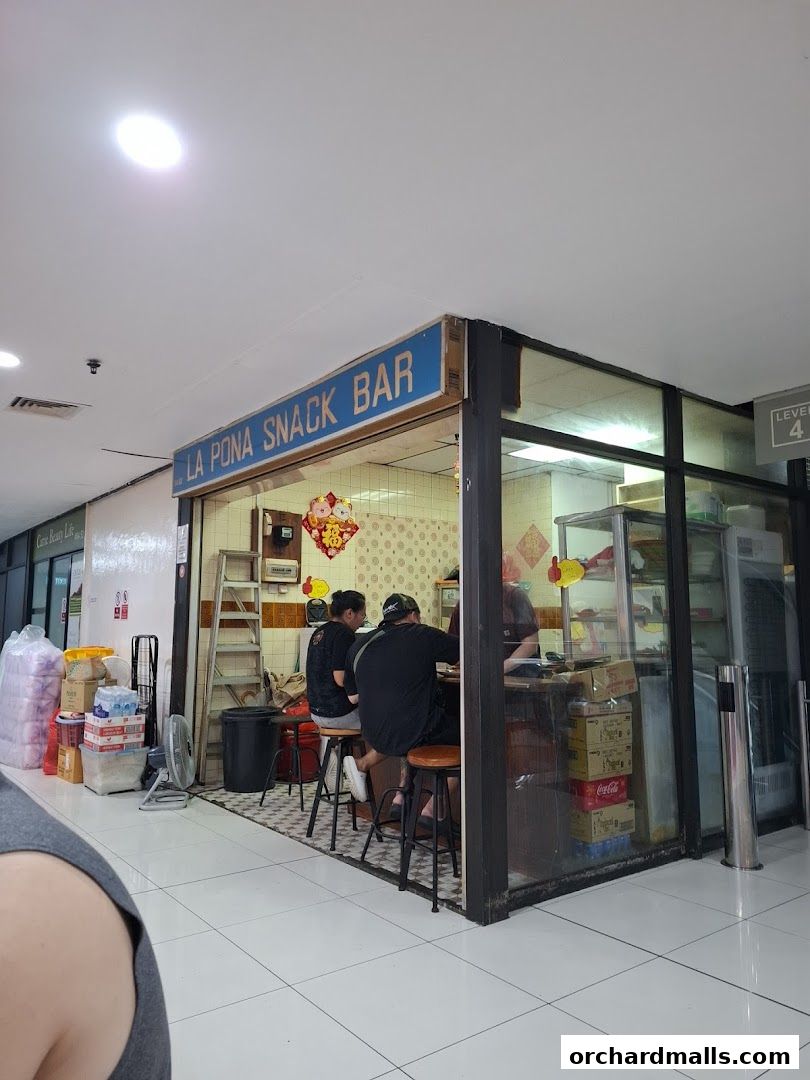 La Pona Snack Bar Nasi Lemak shop front with customers seated at the counter.