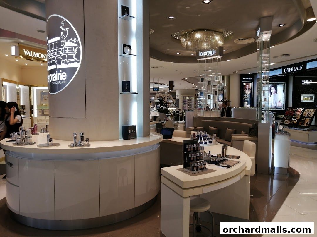 Interior view of a luxury cosmetics store featuring La Prairie and Guerlain brands.