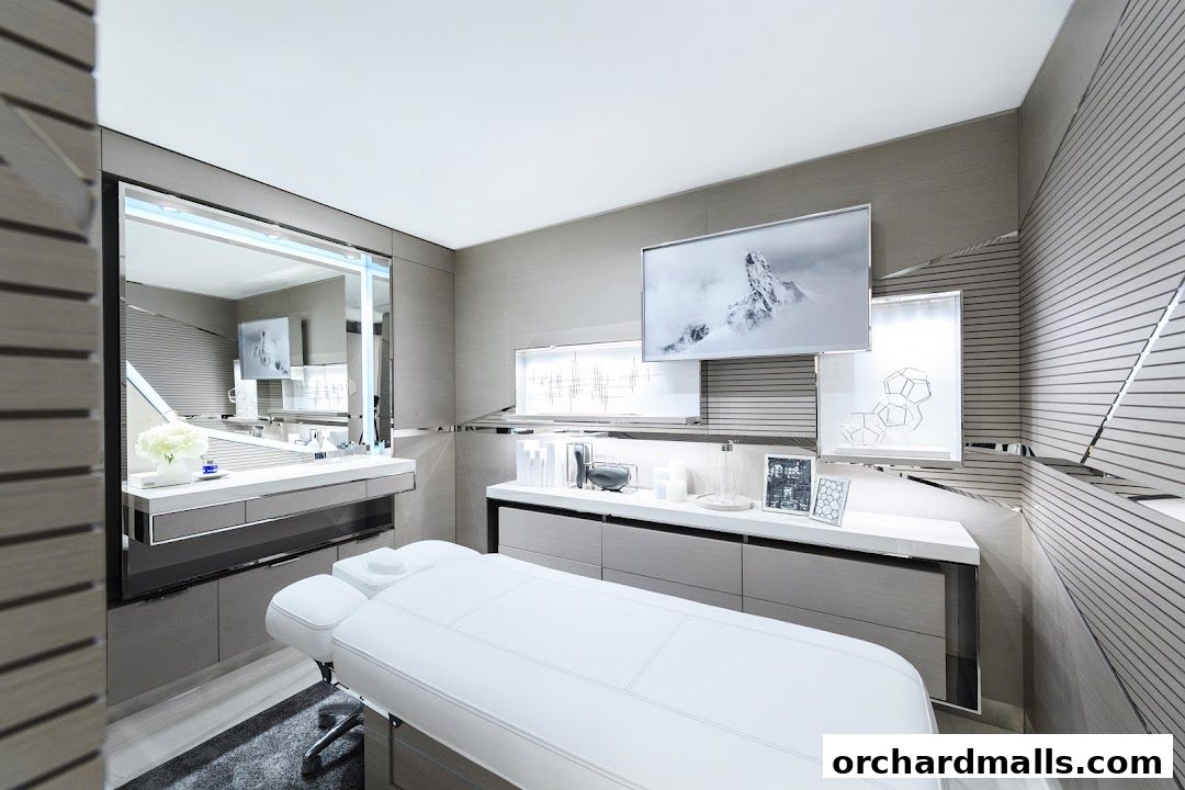 A luxurious spa room with a massage bed, vanity, and elegant decor.
