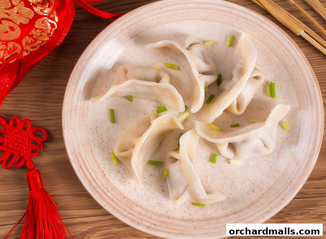 A plate of delicious dumplings garnished with chopped green onions, with festive decorations.