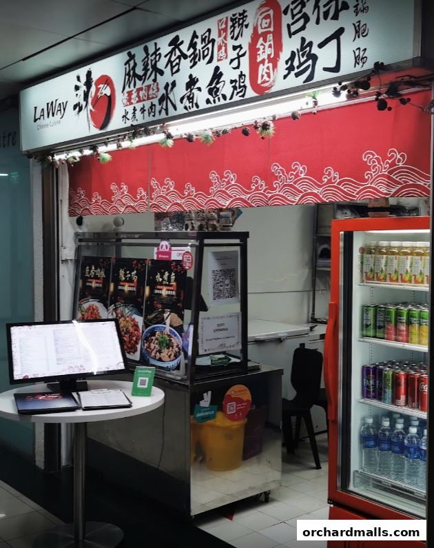 A Chinese cuisine shop front with a red wave-patterned curtain and a display of food.