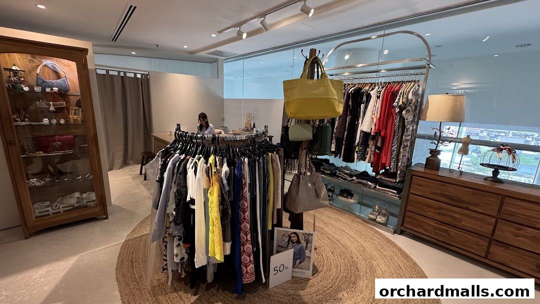 Interior of a clothing boutique with racks of apparel, handbags, and display cabinets.