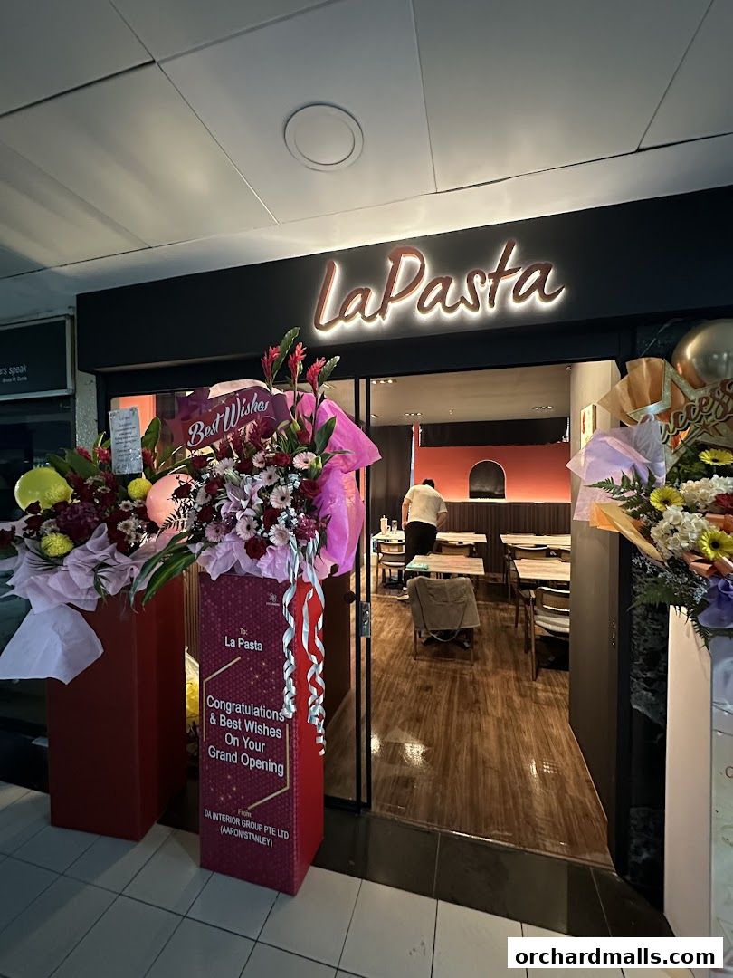 The entrance of LaPasta restaurant decorated with flowers for its grand opening.